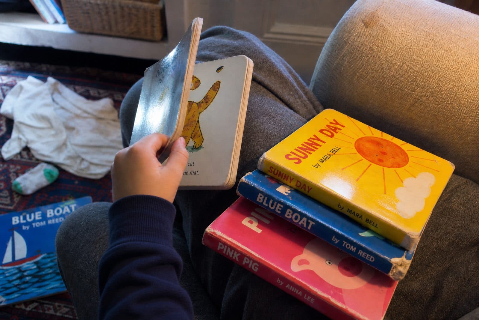A child sharing a well-loved picture book with an adult